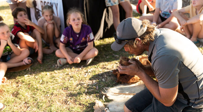 man blowing smoke from fire at edenbrook estate rockhampton community event