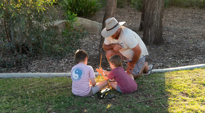 father and two sons build fire at community event in rockhampton