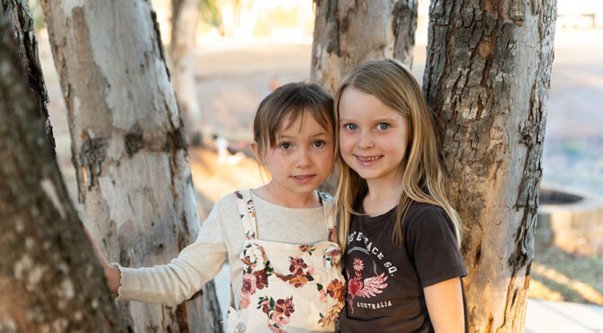 two girls at edenbrook community event smiling at the camera