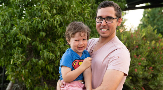 father holding toddler son both smiling at edenbrook estate in rockhampton