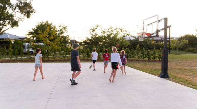 group of children playing basketball on court located in edenbrook estate in rockhampton