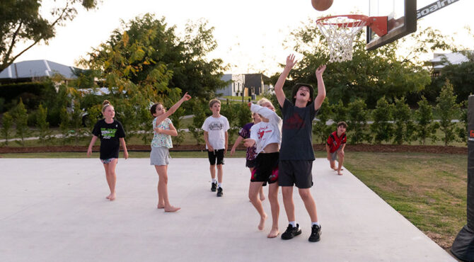 boy shooting basketball on court located in edenbrook estate in rockhampton