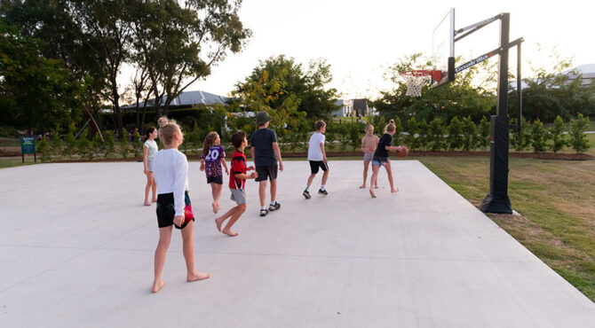 group of children playing basketball on court located in edenbrook estate in rockhampton