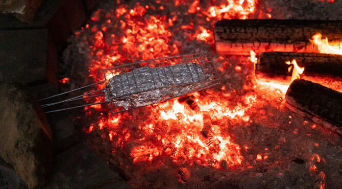 smores being toasted wrapped in foil in holder over fire at edenbrook in rockhampton